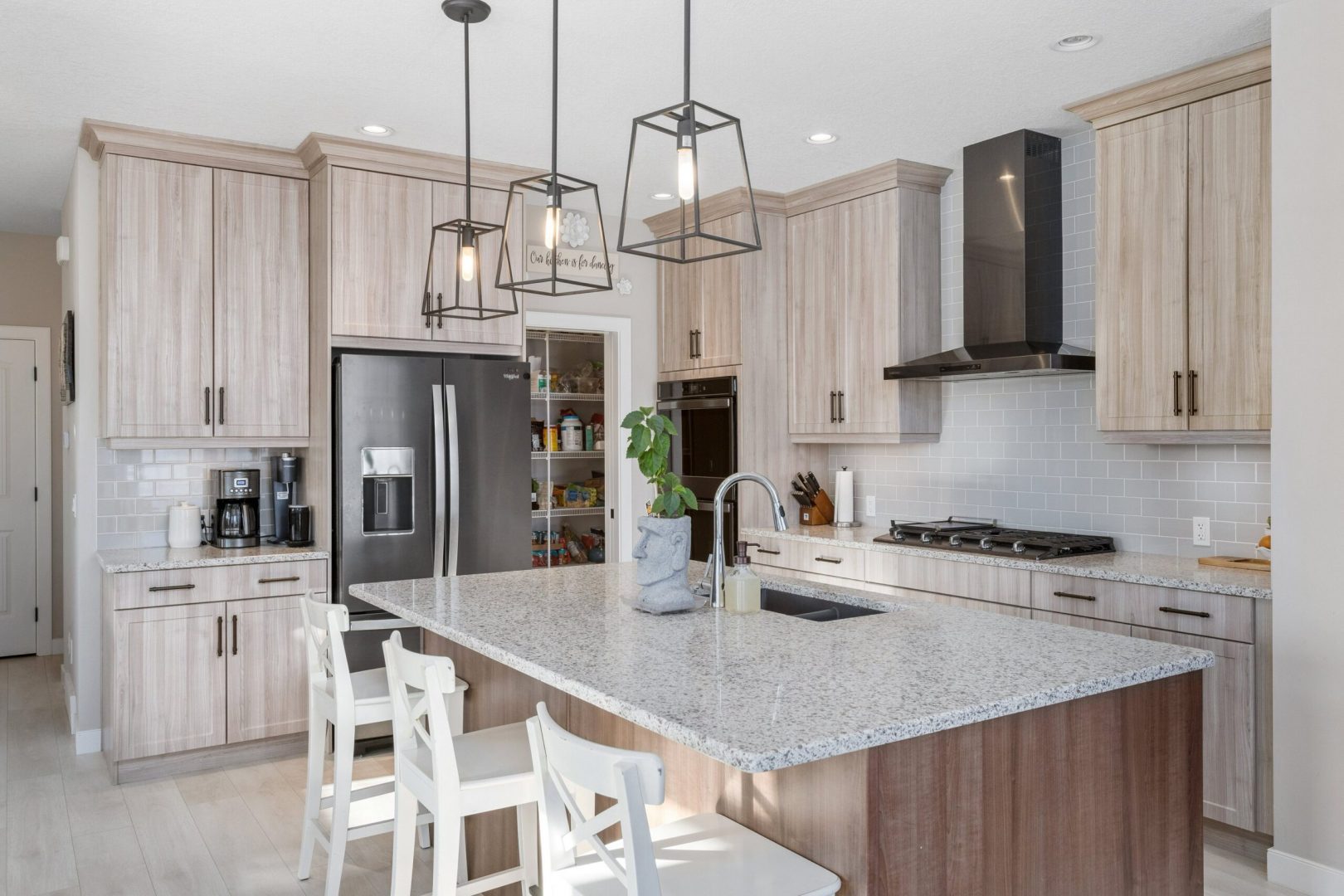 Real Estate Photography. A premium interior photo of a kitchen photographed by Ryan Haggel from Calgary Premium Real Estate Photography.
